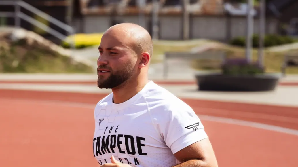 Jason Kuhr running on an outdoor track